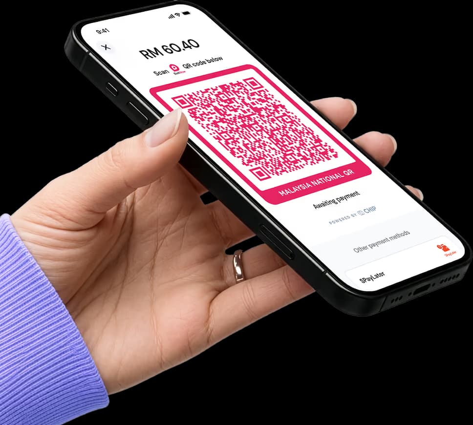 A hand holding a phone showing DuitNow QR screen on CHIP mini app waiting for customer to scan and pay